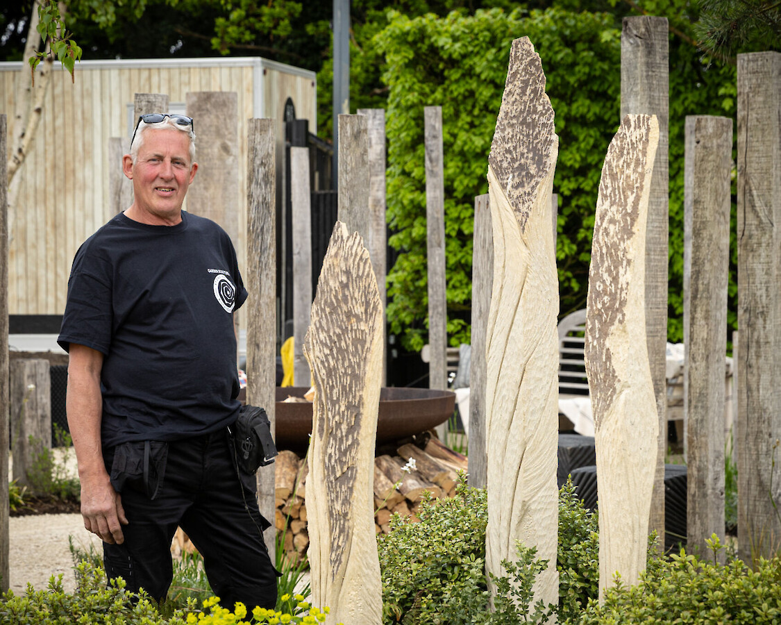 Richard Clegg stood beside his stone sculptures at The Glasshouse Collective.